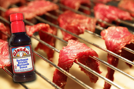 1/4 inch strips of beef on a drying rack with Claude's BBQ Brisket Marinade