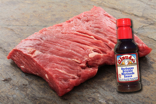 Slab of beef brisket and Claude's Sauces 16oz. bottle of BBQ Brisket Marinade